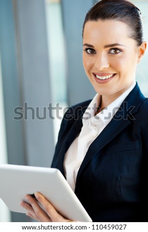 beautiful young businesswoman with tablet computer in office