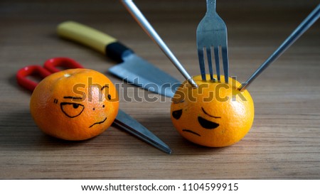 Fresh orange fruit Be hurt isolated on wooden background,emotion face.