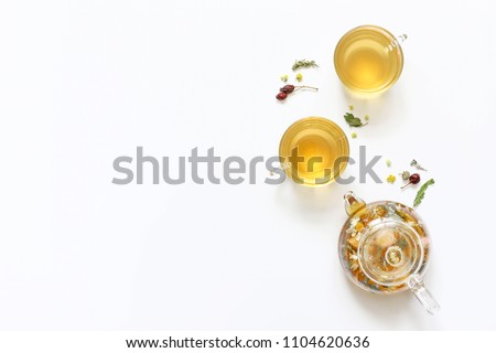 Herbal tea of mint, chamomile, rose hip and other herbs on white background. The view from the top. Copy space Royalty-Free Stock Photo #1104620636