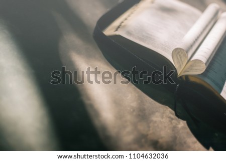 Soft focus open holy Bible at window,heart pages