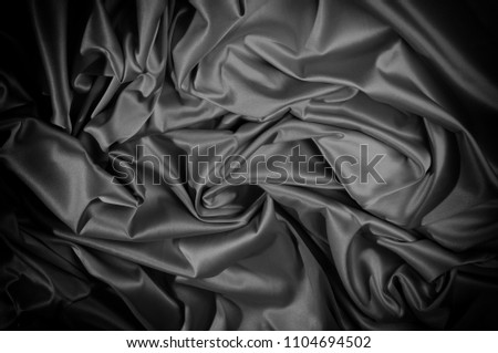  texture of black and white silk fabric This high-quality charmeuse is made of satin weave, yet elastic and beautifully adorns. The front of the fabric has a satin finish, shiny and reflective