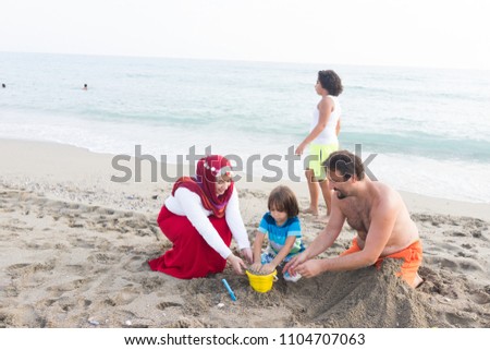Muslim family on beach