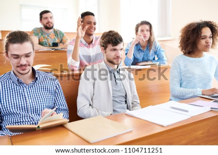 Group of students sitting at lesson and listening to lecture