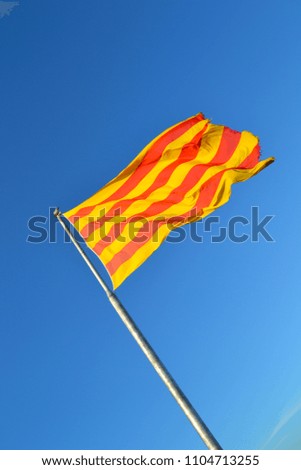 Catalan flag blowing on the blue sky