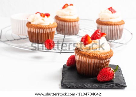 Food concept Fresh homemade strawberry whipped cream cupcake on white background