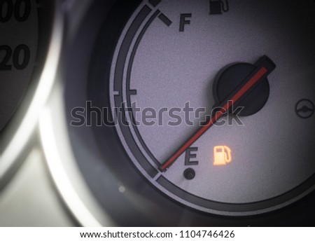 Fuel gauge with warning indicating low fuel tank, gas gauge indicating icon for gas station.