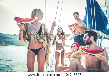 Multiethnic group of friends sailing on a boat - Summer holidays, young adults having fun
