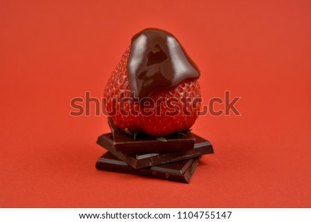 Strawberry with chocolate stock images. Pile of Chocolate with strawberry. Strawberry with chocolate on a red background. Chocolate fruity delicacy. Valentines Day concept