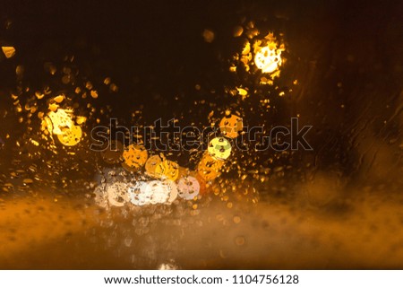 Snow with droplets on the car glass at night