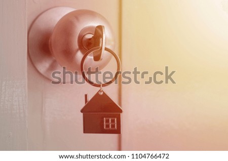 House key in the door housing and real estate, insurance concept.