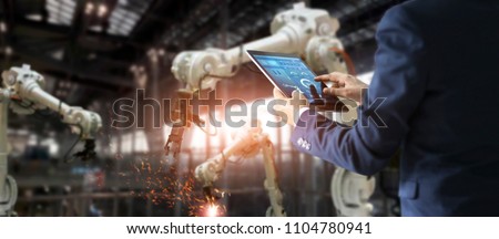 
Manager engineer check and control automation robot arms machine in intelligent factory industrial on real time monitoring system software. Welding robotics and digital manufacturing operation.  Royalty-Free Stock Photo #1104780941