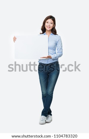 Young Asian woman showing blank board pannel isolated on white background.