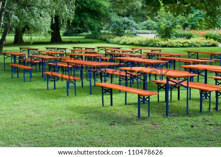 Beer tables and benches in a public park Royalty-Free Stock Photo #110478626