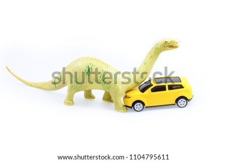 Toy Brachiosaurus dinosaur attack yellow car isolated on white background