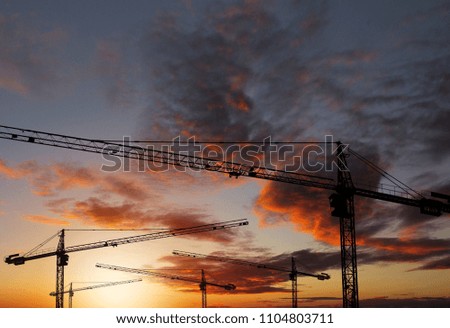 Industrial background, Silhouette of construction crane at sunset sky.