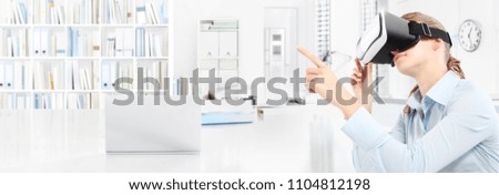 Woman wearing virtual reality glasses headset in office and pointing with hand touch screen, web banner copy space