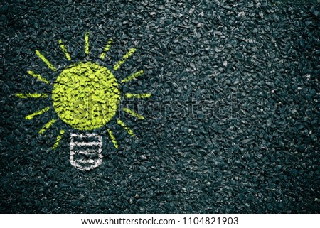 Light Bulb Yellow Chalk Drawing on Asphalt Ground, Suitable for Business Inspiration Concept.