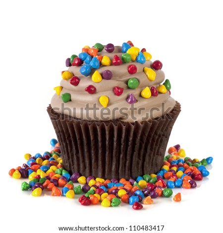 Chocolate cupcake topped with colorful sprinkles.  Isolated on white.