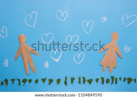 Silhouettes of man and woman on blue background
