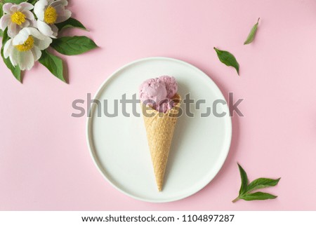 Spring or summer mood concept. Flat-lay of waffle sweet cone with berryy over pastel light pink background, top view