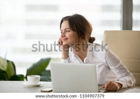 Happy businesswoman looking away satisfied with good new job enjoying business success and wellbeing working in office, smiling woman boss feeling motivated dreaming thinking about future goals
