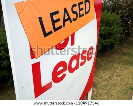 For Lease, Real estate sign with the sticker  saying Leased