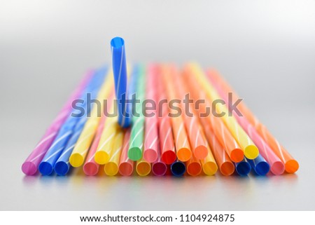 Plastic straw stock images. Harmful plastic straws. Colored straws. Plastic colored straws on a gray background. Colored drinking straws
