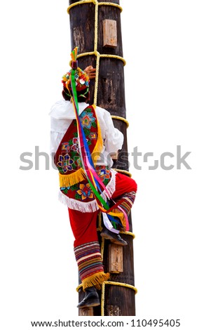 Traditional Mayan Flyer Man Climbing a Wooden Pole in the Dance of the Flyers Ceremony, an old Mesoamerican ritual still performed today