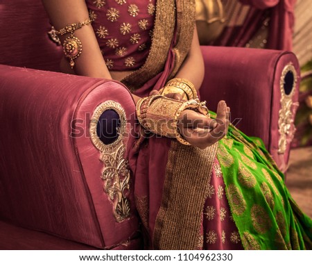 Close up  of Decorative hands of Indian Bride with Golden Jewellery.  Selective Focus is used.