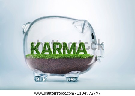 Grass growing in the shape of the word karma, inside a transparent piggy bank.