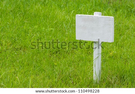 Empty signboard on grass
