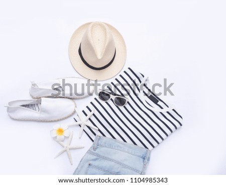 summer striped clothes collage on white,sunglasses,starfish, , hat, shoes ,stone, frangipani ,jeans on flat lay, top view
