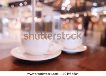 Blur image of Coffee cup on wood table .