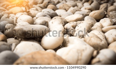 Stone pebbles texture background for interior exterior decoration with sunset