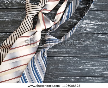 man's tie on an old black wooden background