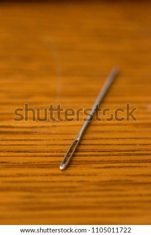 A needle on a table.