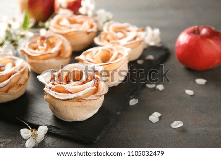Tasty apple roses from puff pastry on slate plate