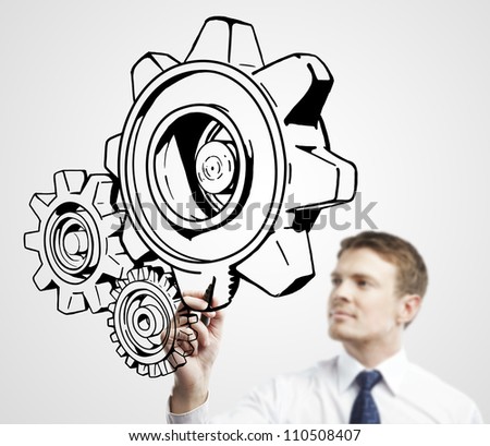 businessman drawing gears on a white background