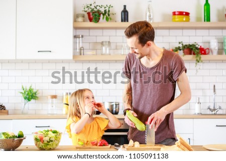 Image of man with his daughter cooking dinner