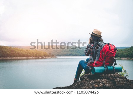 Female tourists in beautiful nature in tranquil scene, concept tourists backpack.