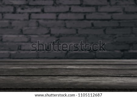 Selected focus empty black wooden table and wall texture or old black brick wall blur background image. for your photomontage or product display.