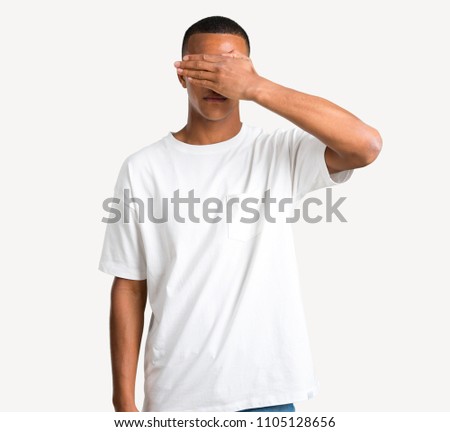 Young african american man covering eyes by hands. Do not want to see something on isolated background
