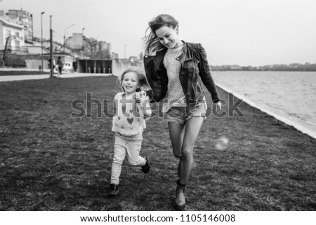 Mother with her little daughter have fun outdoor