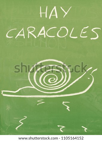"Hay caracoles", there are snails. Green blackboard in a bar of Seville specialized in snails.