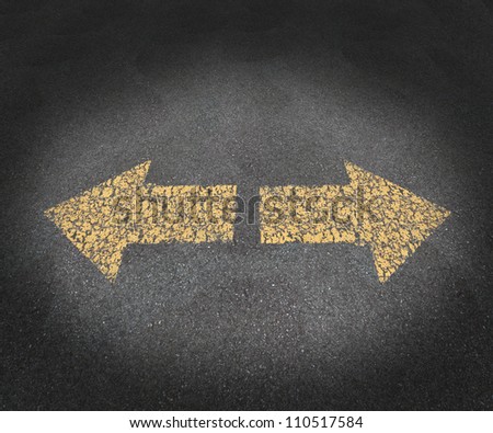 Strategy and decisions concept with a textured asphalt road and two old painted yellow arrows pointing in opposite directions as a business symbol of confusion and uncertainty in the future path.