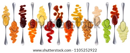 Set of different sauces with spoons isolated on white background Royalty-Free Stock Photo #1105252922