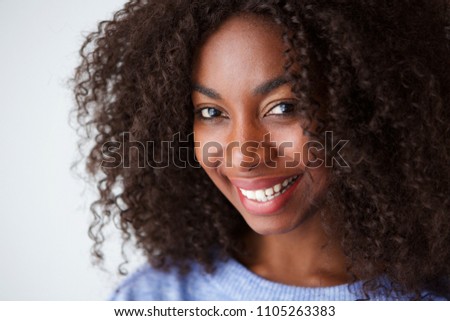 Close up portrait of smiling young african american woman against white background