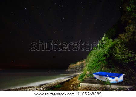 Fishing boat photographed at Shanklin Beach at night with Jupiter in the background sky.