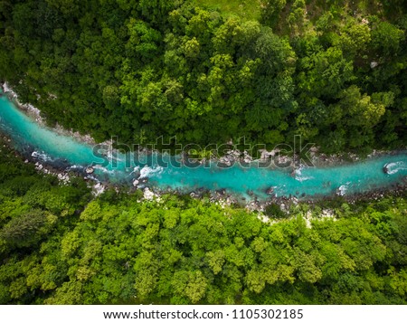 River Soca cutting trough forest, Slovenia. Drone photo. Royalty-Free Stock Photo #1105302185