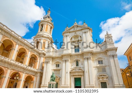 Loreto basilica in sunny day, sculpture and tower, Italy